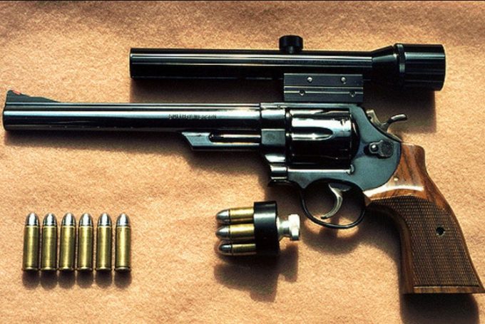 revolver with scope and bullets