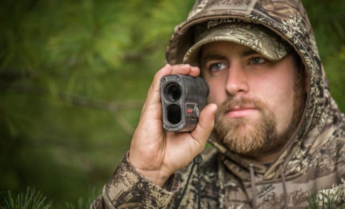 Hunter gauging distance using rangefinder