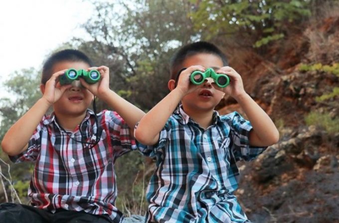 2 kids with binoculars