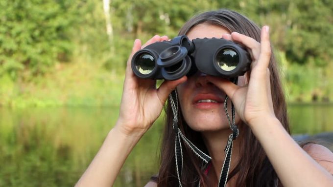 Girl using a binoculars