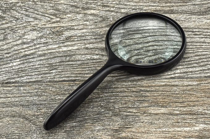 magnifying glass on wooden table