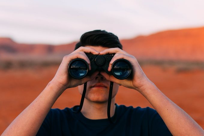 man using binoculars