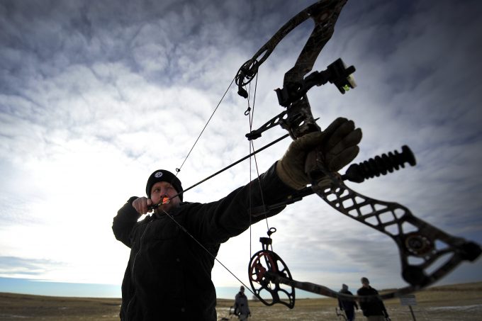 A man shooting a crossbow
