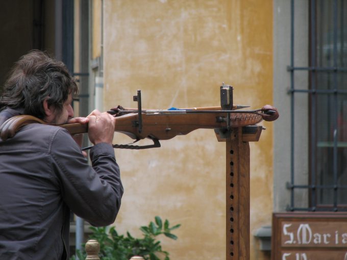 A man shooting a crossbow