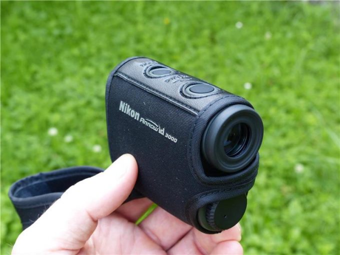 holding a nikon rangefinder