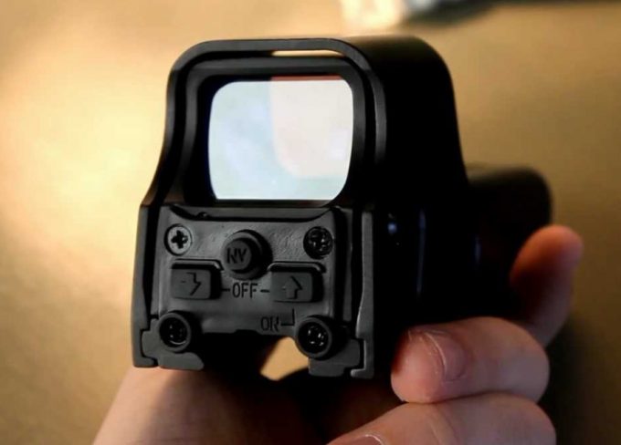 holding a red dot sight